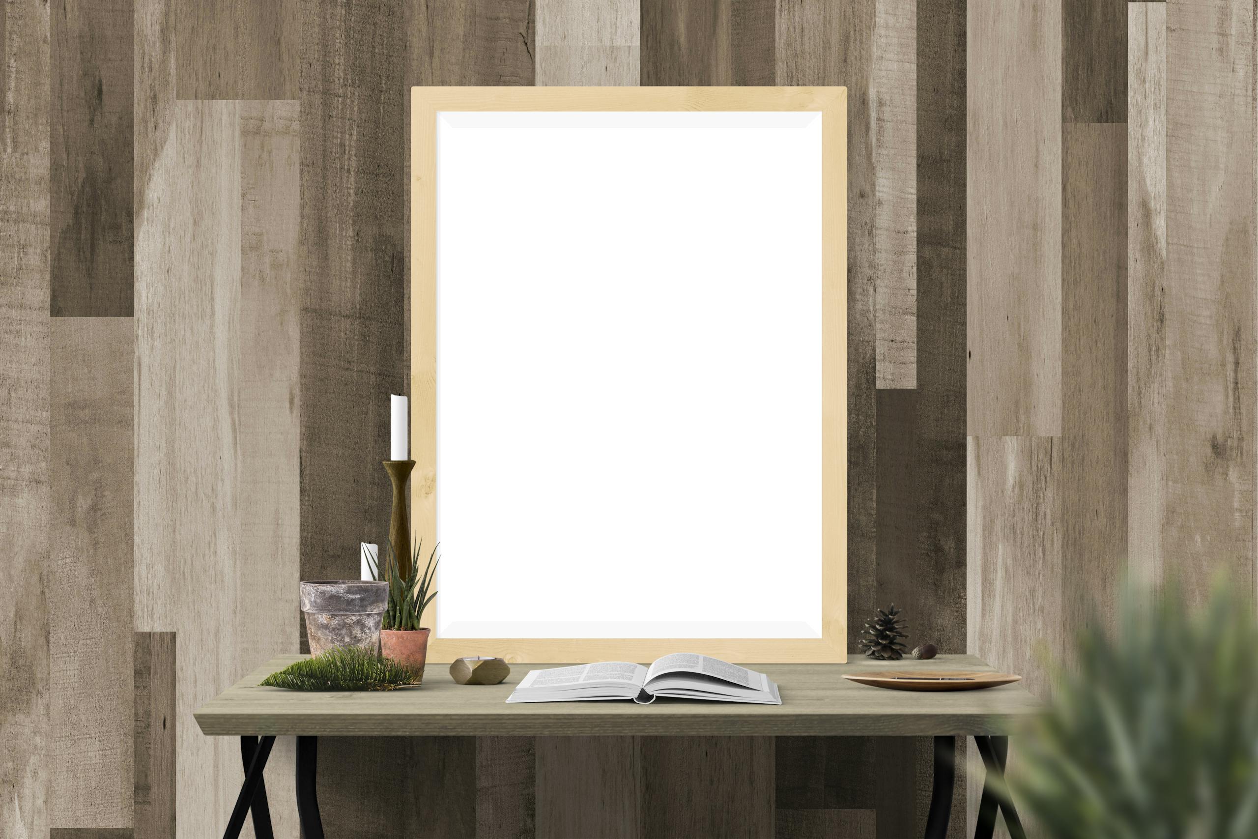 Serlig Cozy indoor setting with a blank frame for artwork surrounded by decor on a wooden table against a textured wall.