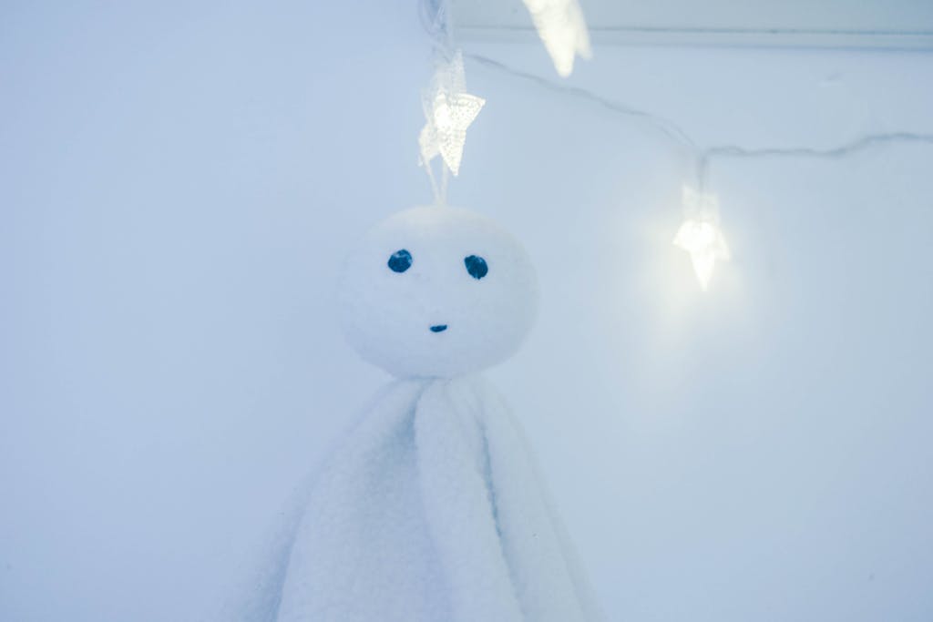 Miami Dolphins  A serene teru teru bozu hanging against glowing star-shaped lights, evoking calmness.