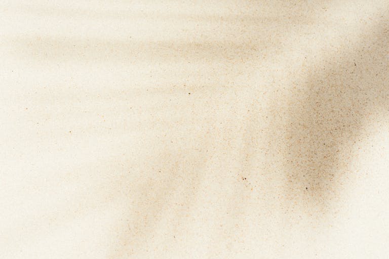 Emfyteymata Artistic sand texture with natural shadows creating a serene abstract pattern, perfect for background use.