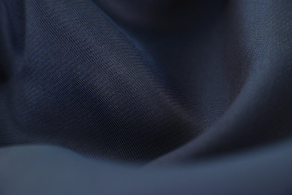 SocialMediaGirl Detailed close-up of woven blue fabric with elegant crumples, highlighting texture and depth.