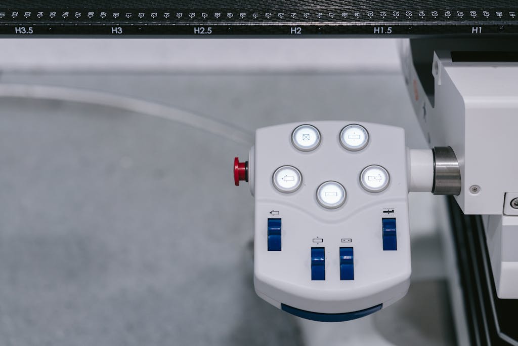 Trios 5 Invisalign Submission Detailed view of a modern industrial control panel with illuminated buttons and switches.