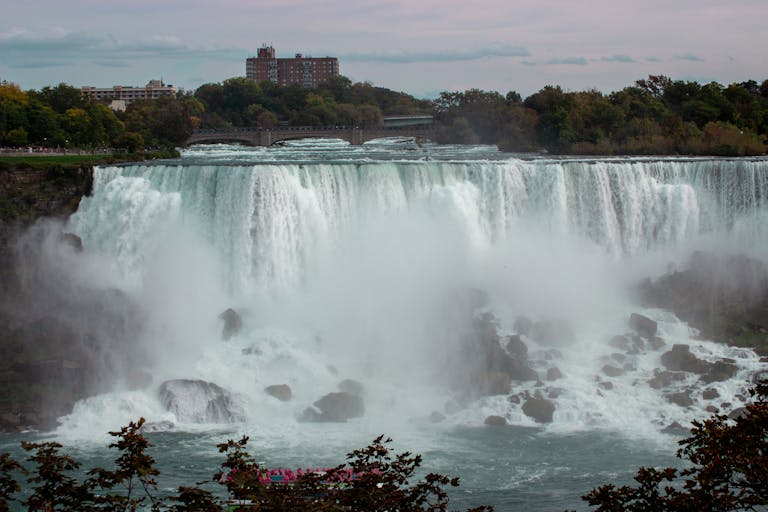 TheGlobeAndMail Majestic view of Niagara Falls cascading into the river below on a calm day.