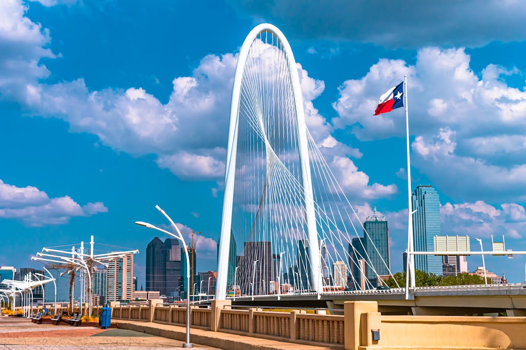 Texas Hunting Forum The iconic Margaret Hunt Hill Bridge in Dallas, Texas under a bright blue sky with clouds.