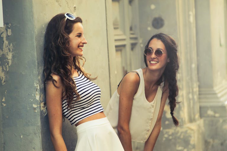 SocialMediaGirls Forum Two young women smiling and posing outdoors in Valletta, Malta.