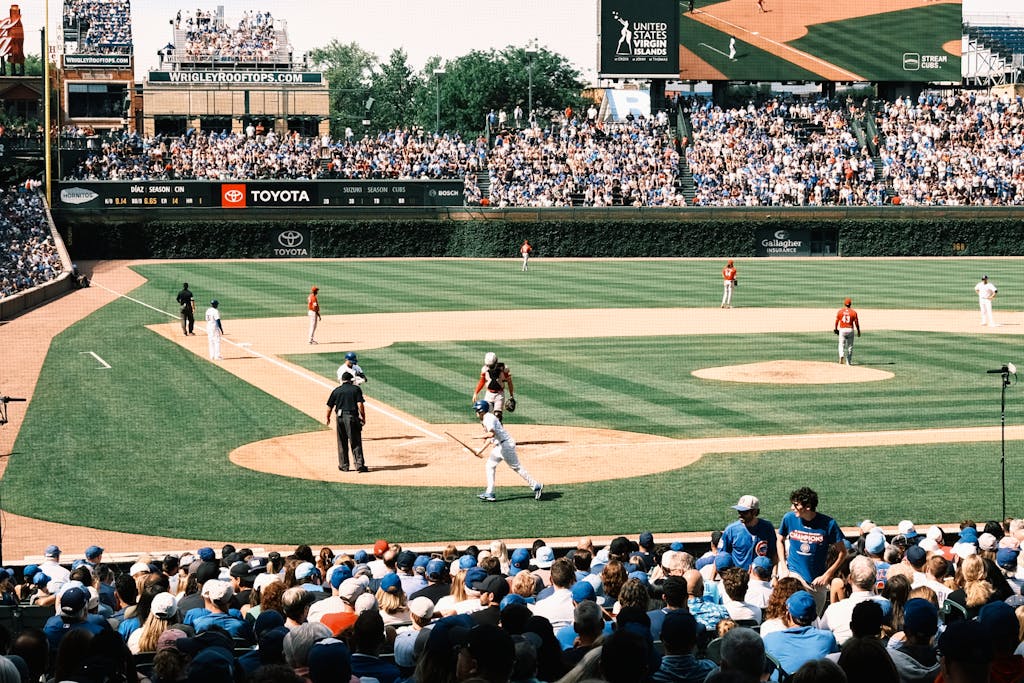 Chicago Cubs vs Miami Marlins Match Player Stats Vibrant scene of a baseball game at Wrigley Field with packed grandstands and players in action.