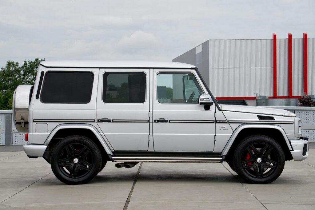 Unbanned G+ designed white Mercedes G-Class SUV showcased in an outdoor setting, perfect for modern automotive enthusiasts.